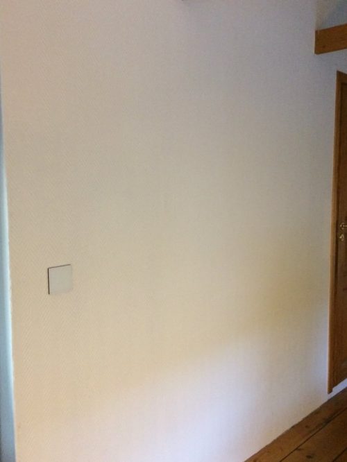 The white switch against the newly painted wall