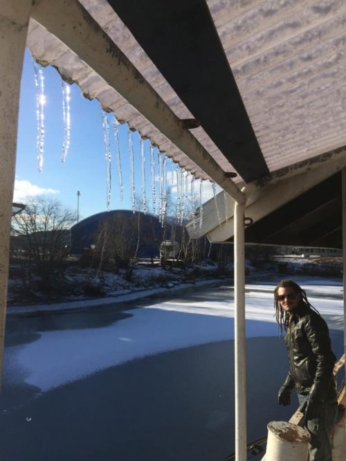 Mike is looking at the icicles hanging from the roof