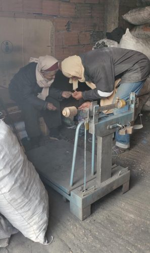 The old man and the man helping us to buy the charcoal