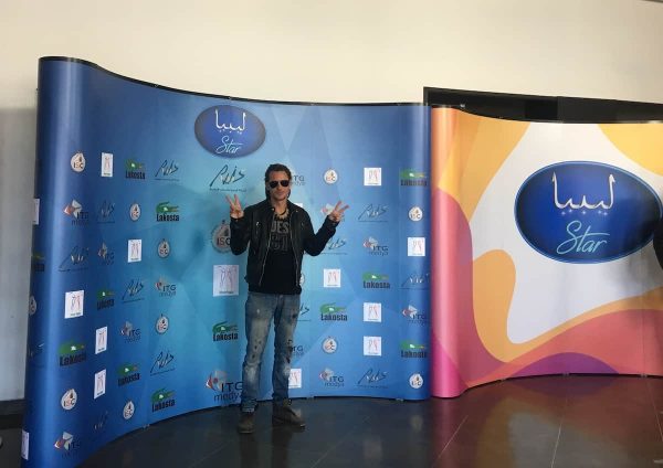 Mike in front of the Libyan star poster